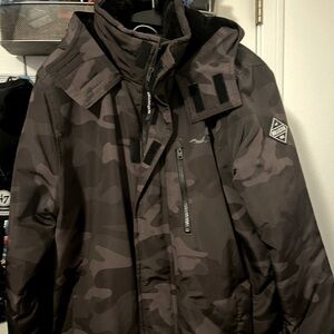 Hollister All-Weather jacket in a black camouflage color. Size M in men’s.
